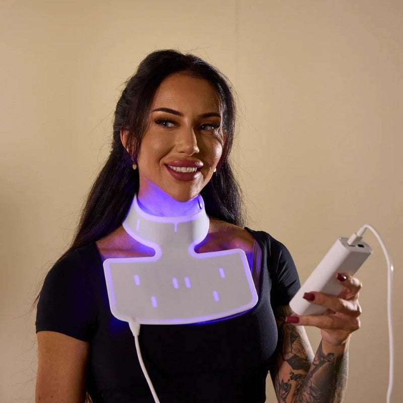 Woman wearing a Floe neck and shoulder LED light device with a remote control.