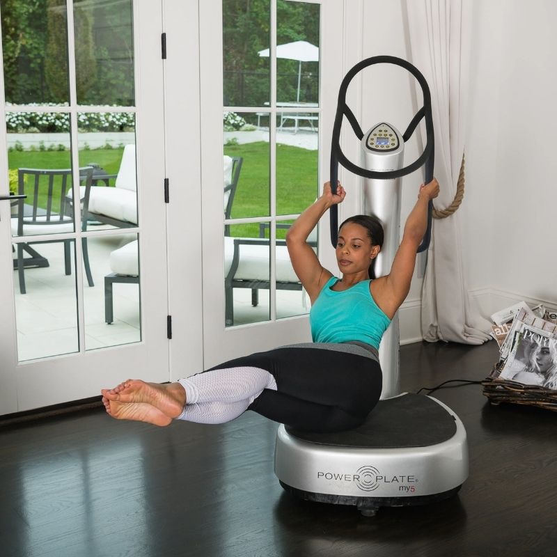 Person using a Power Plate exercise device in a home setting