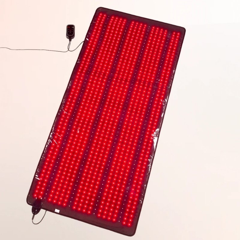 Red LED mat with power adapter on a beige background