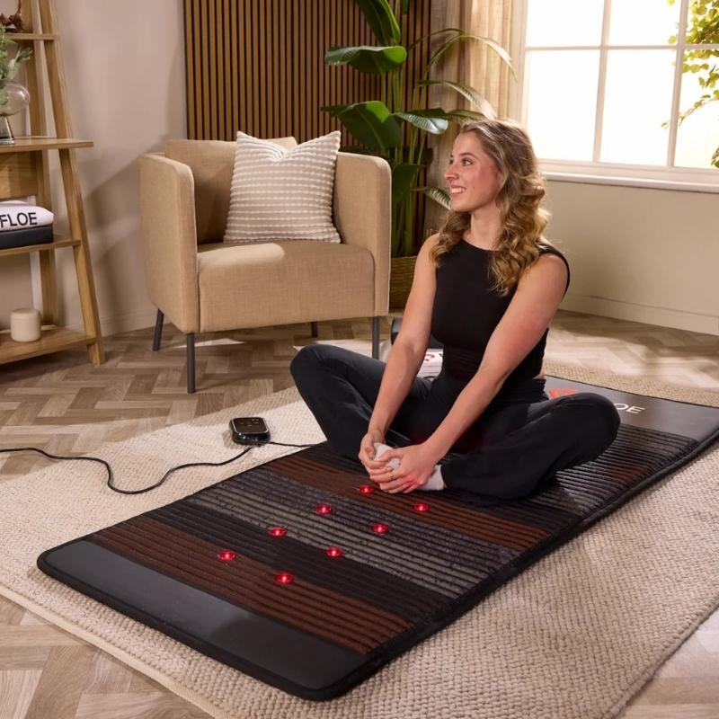 Woman using Floe PEMF mat